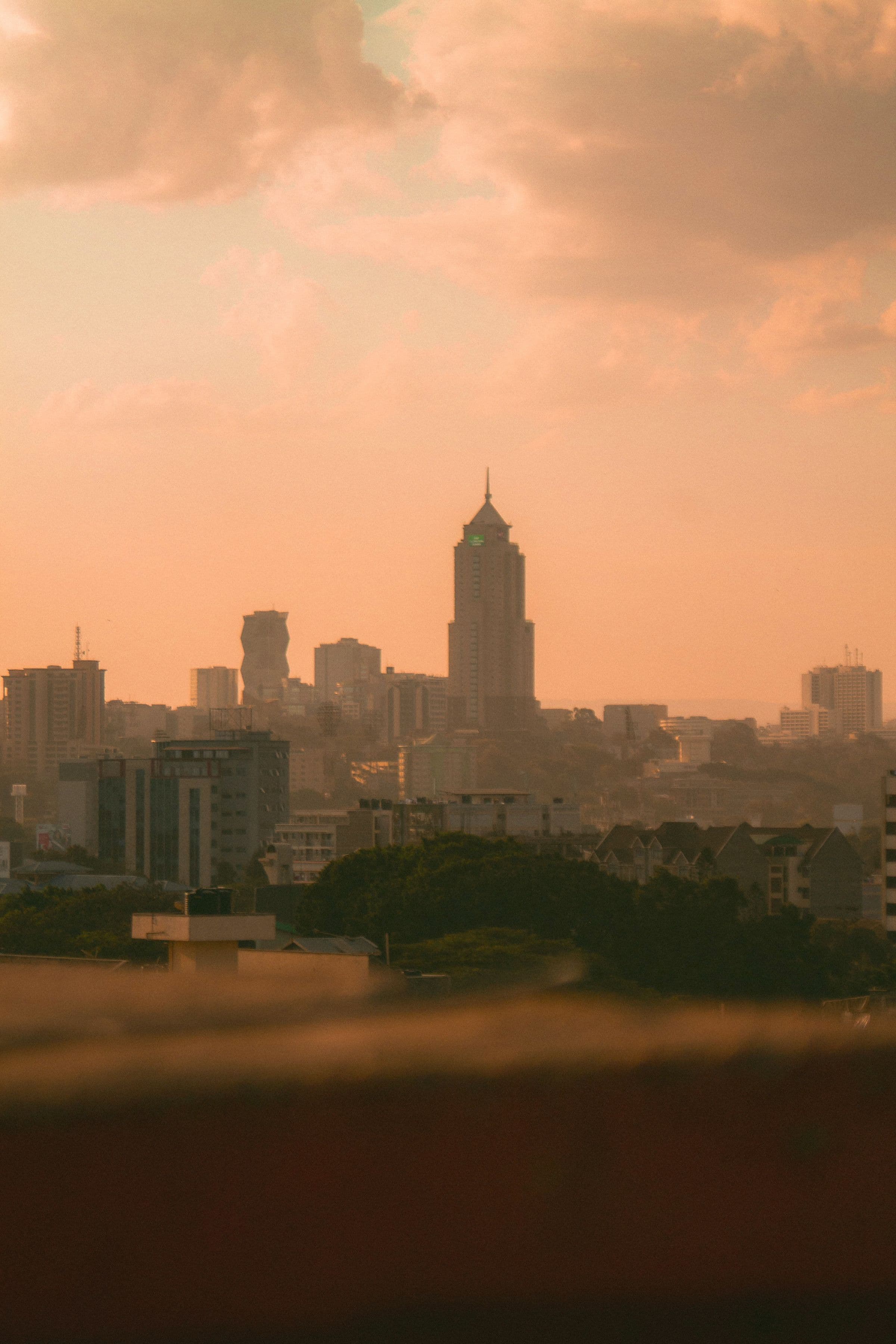 Nairobi skyline with modern commercial buildings under a dramatic sky